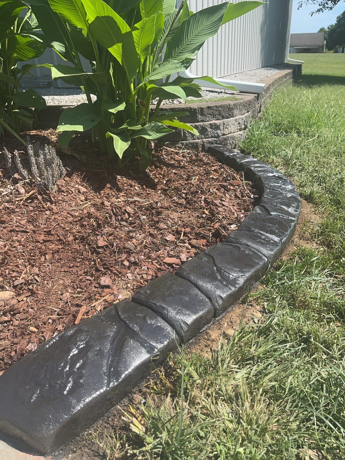 Canna bed below a retaining wall, Chattanooga Rock pattern