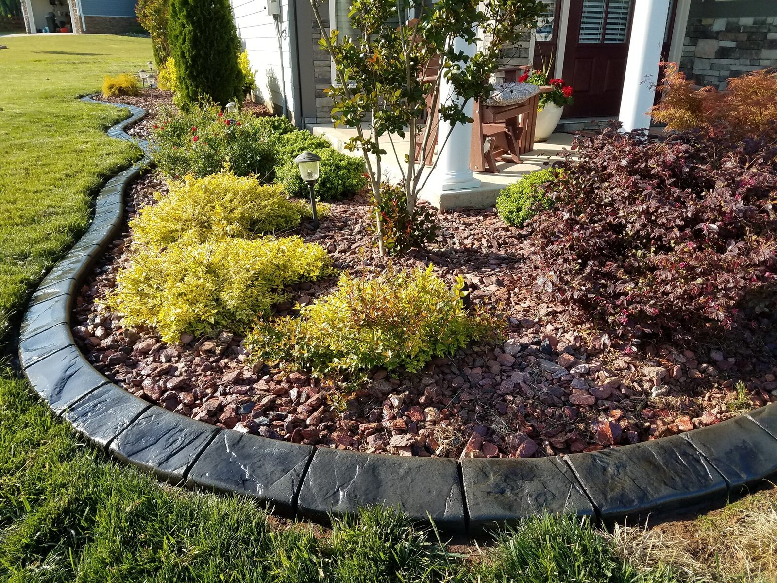 Lava-rock bed at the porch, Riverstone pattern