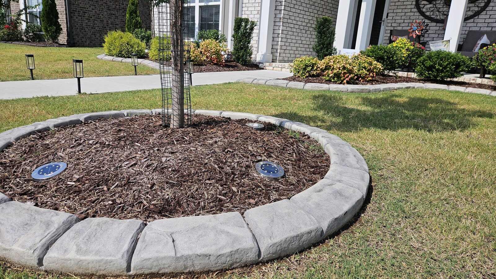 Grey stamped tree ring filled with mulch