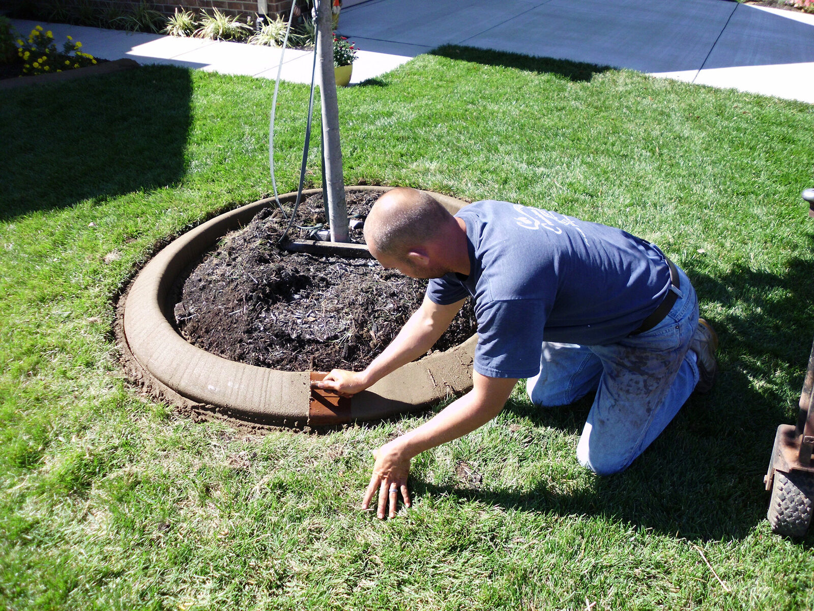 Hand-stamping a freshly extruded concrete curb