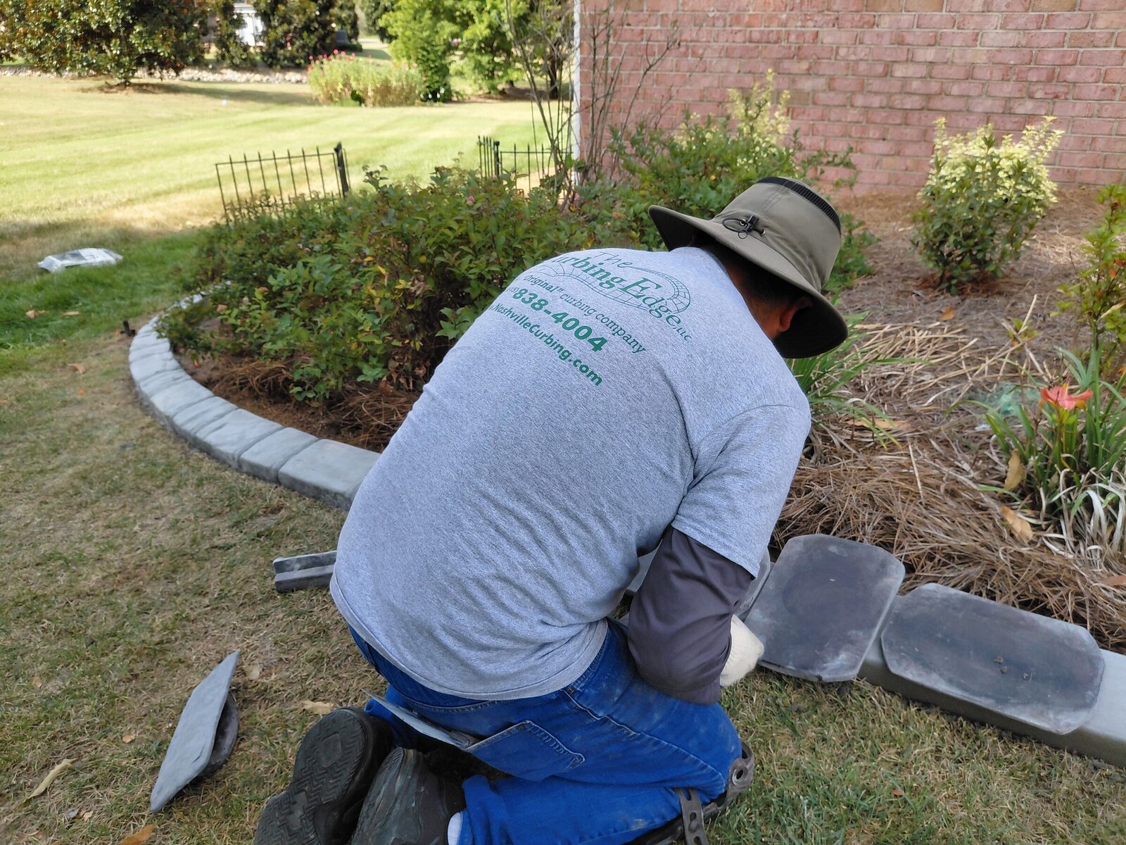 Pressing stamp tiles into the fresh curb