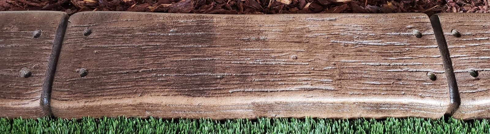 Woodgrain stamp pattern pressed into a curb